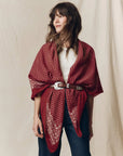 Red floral vintage-style Big Bandana draped over shoulders and cinched with a silver-buckled leather belt.