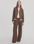 Brown pinstriped blazer and Lawrence tailored pant with white shirt worn by model.