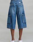 AINSLEY TRIPLE PLEAT CARGO SHORTS by Denimist with oversized flap pockets, shown from the back with white slip-ons.