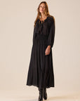 Bella Skirt in Polka Dot Black Tan by Natalie Martin, styled with black boots, shown on a simple backdrop.