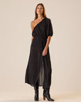 Erin Top by Natalie Martin in sheer black polka dot, 70s-inspired one-shoulder style paired with boots.