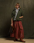 Free City LifeNatureLove zip hoodie styled with a vintage jacket and floral skirt in a cozy indoor setting.