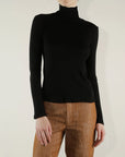 Black ribbed Pharaoh Cleo Turtleneck by Bungalow, lightweight material, modeled against a light background.