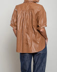 Shiny brown Pharaoh Claude Shirt with voluminous sleeves, styled with dark jeans, Bungalow Furniture & Accessories.