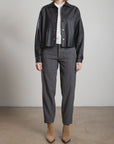Ezra Pant in Wool Pinstripe, grey pinstriped trousers with patch pockets, styled with a white top and black jacket.