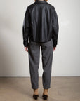Ezra Pant in grey wool pinstripe with drawstring waist, styled with a black jacket and tan heeled boots.