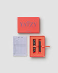 Printworks Yatzy game set in a red box, including a scorecard, five black dice, and two pencils.