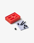 Printworks Yatzy game set in a red storage box with five black dice, two pens, and a score pad.