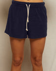 A person models the Perfectwhitetee Summer Loop Terry Sweat Shorts in navy blue, standing against a light background, shown from waist to just below the knees.