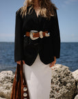 Tan Italian suede Western belt with antique silver buckle styled over a black blazer.