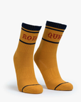 These Baby Steps tube socks by Mother boast a classic mustard-yellow design with bold black toes and cuffs. A black stripe accentuates the top, while one sock displays "ROB" and the other "OUR" in eye-catching red lettering, making them perfect for unleashing your inner Rodeo Queen.