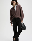Classic Rugby Polo by Sold Out NYC styled with a crisp white shirt and black accessories for a chic, modern look.