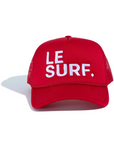 The Le Surf Hat by Ping Pong Surf Club is a red mesh snapback with "LE SURF." embroidered in white on the front, shown against a white background.