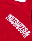 The Wet Suit & Cowboy Boots Hoodie by Ping Pong Surf Club is a red, iconic piece with "WETSUITS & COWBOY BOOTS" in bold white lettering, made from a soft cotton-polyester blend.