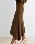 Brown knit Rachel Comey Lenco Skirt with handkerchief hem, styled with cream block-heeled shoes, side view.