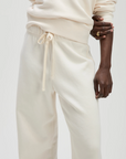 Cream French terry sweatpants by Sold Out NYC styled with a matching sweatshirt and gold ring.