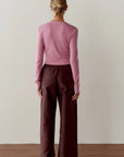 The Taffeta Drawstring Cargo Pant in dark brown worn with a pink cropped ribbed top, back view.
