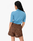 Clare Vivier St. Martin Shorts with a light blue ribbed top, casual summer style, model shown from the back.