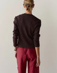 The Sweater Rib Cardi in dark brown, a close-fit long-sleeved rib knit sweater shown from the back.