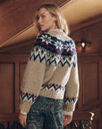 Beige alpaca Winter Fairisle Cardi with a blue, red, and white Nordic pattern on the shoulders and sleeves.