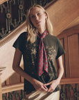 Red pleated vintage bow tie with a geometric pattern, worn over a gold star print grey t-shirt, Bungalow.