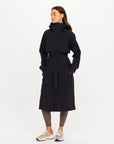 The Upside James hooded trench coat styled with patterned leggings and sneakers, casual modern look.