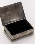 The 88-6 Silver Box w/ Longhorn by J Alexander Rustic Silver is a handcrafted rectangular box with a hinged lid, featuring a textured rustic silver exterior and smooth dark-lined interior. Shown open on a plain, light background.