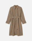 The Plaid Mac Coat by FRAME features a brown, black, and white plaid pattern, belted waist, collar, button front, and adjustable cuffs. Made from structured cotton blend for a tailored look. Shown on a white background.