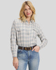 Muted blue and white plaid cotton flannel Western shirt by Sarah Alexandra, LLC, tucked into blue jeans with a brown belt.
