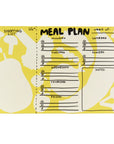 The Faire Meal Planner Notepad is a yellow and white weekly planner with sections for each day, notes, and a shopping list. It features playful food shapes like pears and mushrooms in the background.