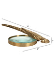 Antique brass Norine magnifying glass with a long textured bird handle and labeled dimensions by Bungalow Furniture.
