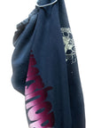 The Artyard Yumm OG Sweatpant by Free City (sparrow, LLC) in navy blue features a large pink and white graphic text on the leg and a partially visible skull design with white text near the pocket.