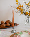 Faire’s Carrot Beeswax Candles are handmade and come in a candle holder.
