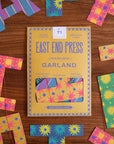 Yellow Faire Paper Garland package on wooden table with festive paper chains, styled for a cheerful birthday setting.