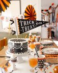 Black and white Halloween cake on styled table with vintage decor, Bungalow Furniture & Accessories ambiance.
