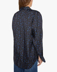 The Bestie button-up shirt in black with a blue star pattern, styled with blue jeans.