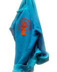 A blue French terry Artyard SUPERSHOP STAMP Raglan by Free City (sparrow, LLC) hangs against a white background, featuring orange and red "yard camp" graphics, visible sleeves and cuffs, and a slightly wrinkled finish.