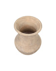 The Dalona Short Vase by The Import Collection is a handcrafted beige clay pot with a wide mouth, narrow base, and subtle patterns near the bottom—a unique modern vase set against a white background.