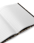 The Faire Leopard Journal is an open hardcover notebook with lined pages and a stylish brown and tan leopard print cover, shown against a white background.