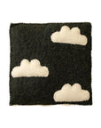 The Indaba Cloudy Day Wall Plaque features a rectangular black felt base with three white felt cloud shapes, creating charming handmade wall art or kids room decor. Shown against a plain white background.