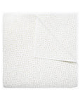 The John Robshaw Hand Stitched Coverlet Queen features a white, organic cotton design with subtle stitched details and is reversible, shown neatly folded with one corner turned down to display stitching on both sides.