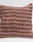 The Faire Blossom Block Print Euro Sham features a brown background with a repeating pattern of small white, blue, and black floral shapes and striped trim—perfect for adding artisan-crafted charm to your bohemian bedding ensemble.