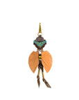 The Daniel Multico Charm by Jerome Dreyfuss features a turquoise mask, gold accents, and orange wings—an artistic keyring or carabiner bag charm that adds whimsical style to your leather bag accessory collection.