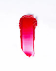 A swipe of Faire 03 Tinted Lip Balm & Blush on a white background shows a gradient from deep red to bright pink with a visible tinted, balm-like texture.