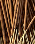 A close-up of several brown Lagoon Incense Sticks | Lush & Seductive by Faire, featuring wooden stems arranged in a scattered pattern for a luxurious fragrance and clean-burning incense experience.