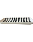 Black and white striped serving platter by Faire, shown side view with bold vertical stripes on a white background.