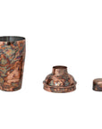 The Creative Co-op Stainless Steel Cocktail Shaker is a three-piece set with an oxidized copper finish, featuring the main cup, strainer top, and small cap arranged in a row on a white background.
