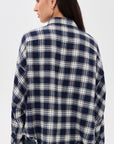 Cropped Denimist work shirt with frayed hem in blue, paired with jeans, shown from the back at Bungalow.