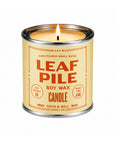 Lit Leaf Pile Soy Candle in a metal tin by Faire, with orange label text on a cream background.