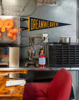 Dreamweaver Pennant by Faire displayed with an orange juice machine on a wood table in a modern kitchen setting.